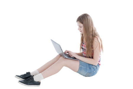 portrait of the young beautiful girl working at the computer on a white background