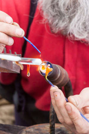 VELIKY NOVGOROD, RUSSIA - 13 MAY:The man casts figures from glass, RUSSIA - 13 MAY 2017.In Russia national crafts are widely developedのeditorial素材