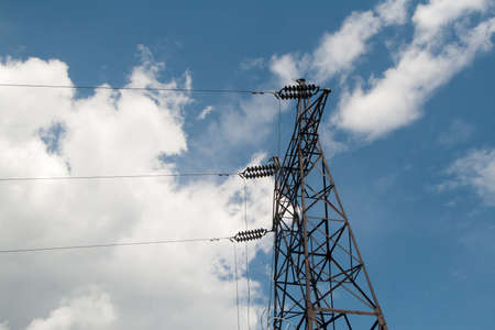 High-voltage electric main against the dark blue sky in summer dayの写真素材
