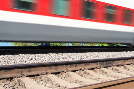 cars of the train moving on rails in clear summer day