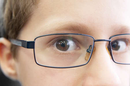 close portrait of the young boy wearing spectaclesの写真素材