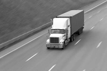 the truck goes on the highway in clear summer dayの写真素材