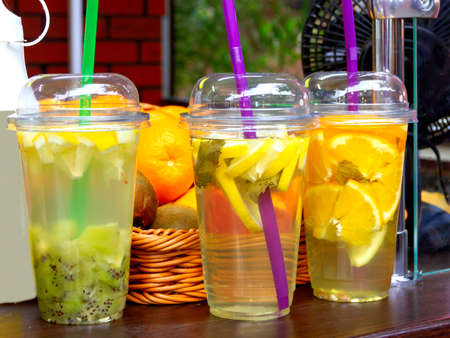 Colorful tonic cocktails on store counter on bright summer day