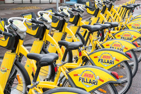 Helsinki,Finland-October 25,2016:Yellow city bicycles for rent stand in a row.In Helsinki, bicycle...