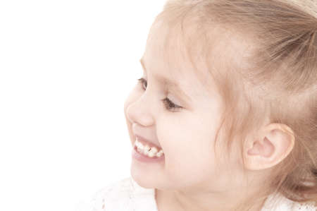 closeup portrait of a little smiling three year old girl on a white background, isolate