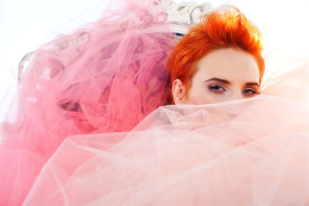 Redhead woman covered in tulleの写真素材