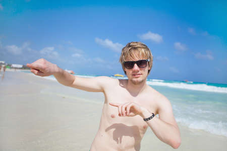 Young man dancing on the beachの写真素材