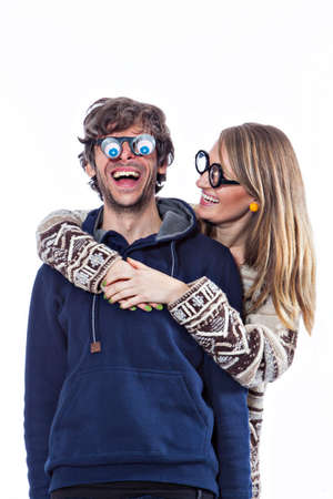 Happy couple fooling around in funny glassesの写真素材