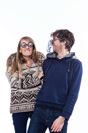 Happy couple fooling around in funny glasses