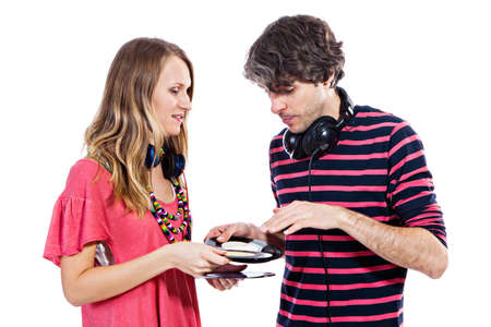Happy young couple playing around with vinyl records isolated on a white backgroundの写真素材