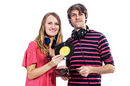 Happy young couple playing around with vinyl records isolated on a white backgroundの写真素材