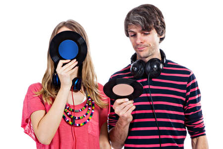 Happy young couple playing around with vinyl records isolated on a white backgroundの写真素材