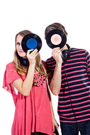 Happy young couple playing around with vinyl records isolated on a white backgroundの写真素材