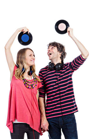 Happy young couple playing around with vinyl records isolated on a white backgroundの写真素材