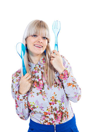 Beautiful blond holding spoon and fork isolated on white backgroundの写真素材
