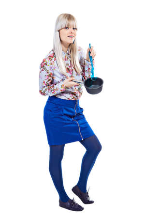 Beautiful girl holding pot and mixing it isolated on white backgroundの写真素材