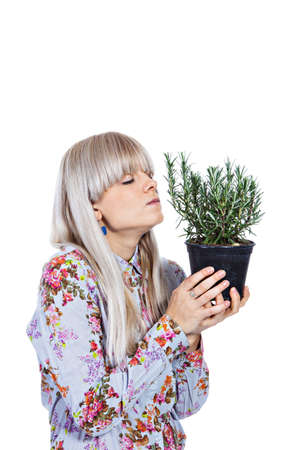Beautiful blond girl holding fragrant potherb isolated on white backgroundの写真素材
