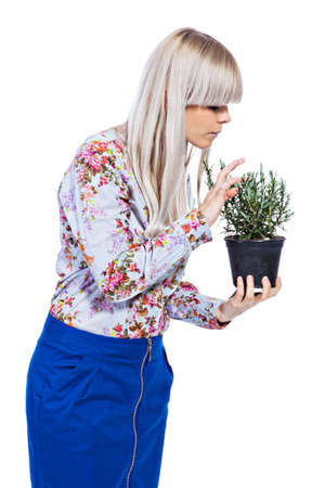 Beautiful blond girl holding fragrant potherb isolated on white backgroundの写真素材