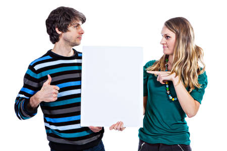 Young couple holding white board isolated on white backgroundの写真素材