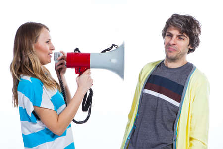 Woman using megaphone to talk to a husbandの写真素材