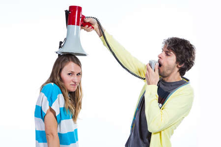 Man using megaphone to talk to a wifeの写真素材