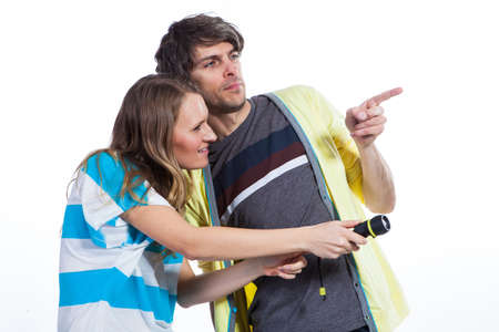 Couple playing with a flashlightの写真素材
