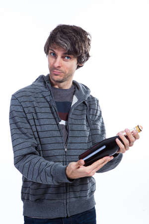 Man inspecting red wine bottleの写真素材