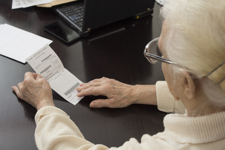Old woman in doctor's office. The old woman holds in her hands a prescription and readsの写真素材