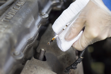 Oil level measure, oil level dipstick in the engine. Oil level at minimumの写真素材
