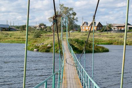 Russian rural landscape with a bridge over riverの写真素材