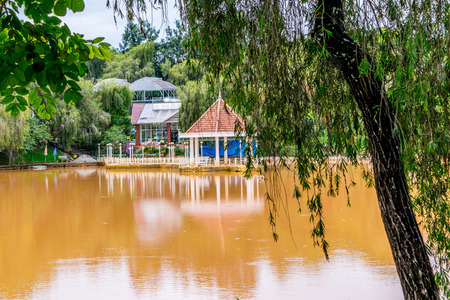 Pond with round pavilion on a water at a park of flowers at Vietnamの写真素材