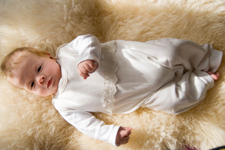 newborn happy sweet baby on furry blanket in soft colorsの写真素材