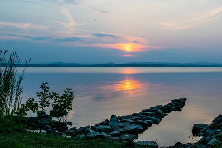 Romantic Stone dock, walkway in a lake at a sunset, Uveldy, The Urals, Russiaの写真素材