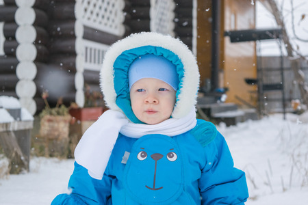 Baby boy walking at a snow yard - winter outingの写真素材