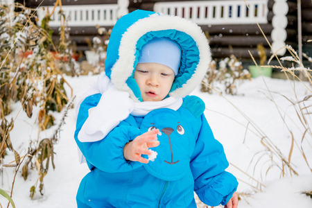 Baby boy surprised with snowの写真素材