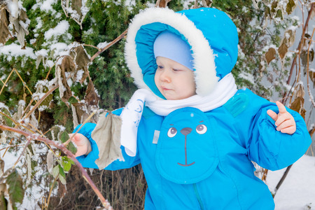 Baby boy surprised with snowの写真素材