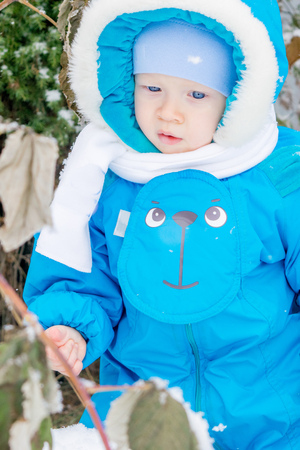 Baby boy surprised with snowの写真素材