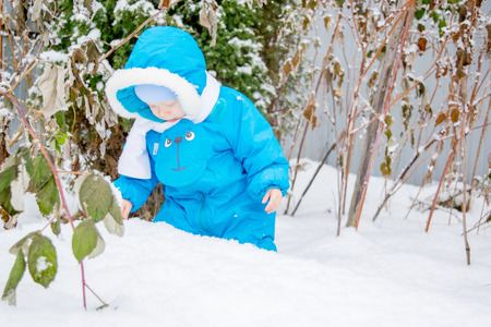 Baby boy surprised with snowの写真素材