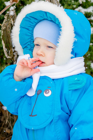 Baby boy surprised with snowの写真素材