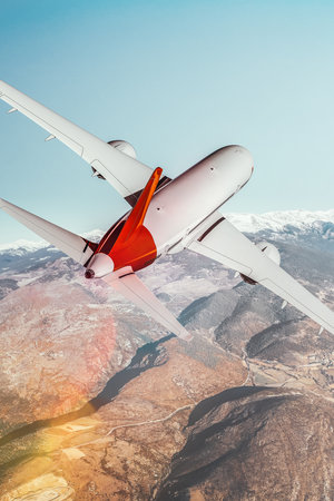 View from behind a commercial plane flying over the mountains. Blend of 3D and raster imagesの素材