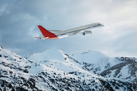 Side view of a commercial plane flying over the snowy mountains. Blend of 3D and raster imagesの素材