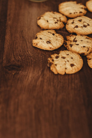Savoring Simplicity: Homemade cookies and a glass of milk on an elegant wooden table.の写真素材