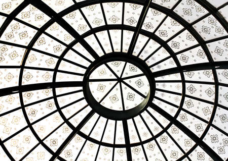 Closeup detail photo of grand round symmetric roof ceiling architecture with flowers as decorationsの写真素材