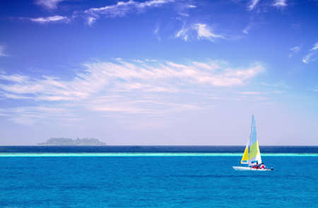 Photo of Sailboat in clear sky along Maldive coastの写真素材