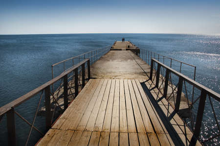 Calm sunset with a jetty on a lake