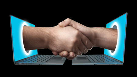 A hand comes right out of the laptop screen to shake hands CONCEPT. isolated on black background High resolution の写真素材