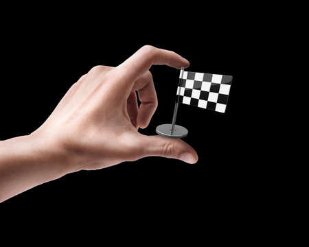 Man's hand holding Checkered Flag isolated on black background の写真素材