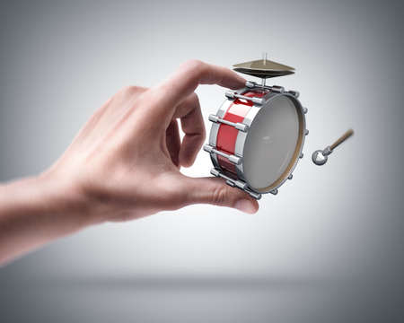 Man's hand holding Bass drum instrument の写真素材