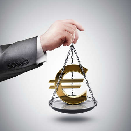 businessman hand holding Scale with symbols of currencies Euro