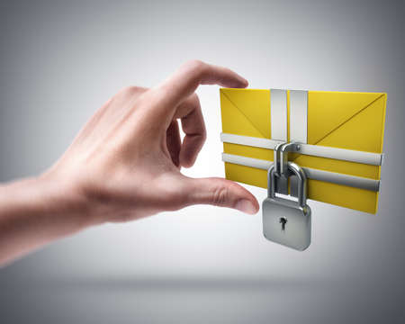 Man's hand holding Yellow mail and lockの写真素材